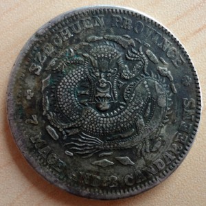 Szechuan dollar struck over a Sinkiang 1917 tael (obverse)